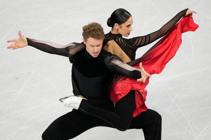 Team USA's Evan Bates (left) competes with his wife and ice dance partner Madison Chock (right) in the free skate on Wednesday. (AP Photo/Natacha Pisarenko)